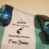 A bag with sunglasses on it and the words " free state."