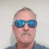 A man with sunglasses on and beard