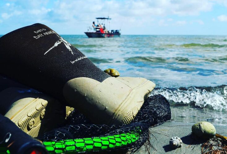 A boat is in the water near some debris.